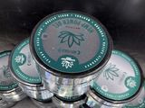 a pile of marijuana tins sitting next to each other