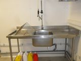 a stainless steel sink in a small kitchen