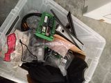 a plastic container filled with assorted items sitting on the floor