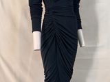 the dress is black and has long sleeves and a v - neck