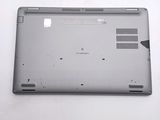 someone is removing the back panel of a laptop with a plastic opening tool