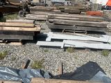 a lot of wood on the ground next to a building