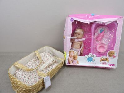 a baby doll in a basket next to a doll in a basket