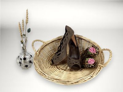 un panier sur lequel sont posées une paire de chaussures et un vase avec des fleurs