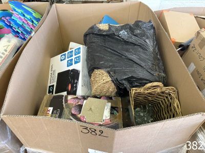 a cardboard box filled with assorted items in a room