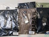 quatre paires de t-shirts pour homme dans des sacs en plastique posés sur une table