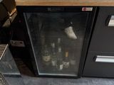 a wine cooler sitting on the counter in the kitchen