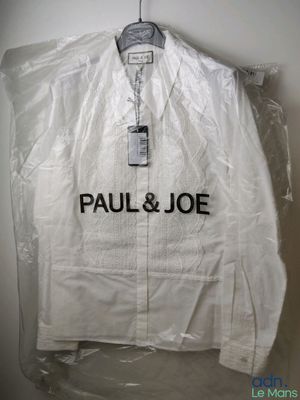 a close up of a plastic jacket on a hanger on a wall