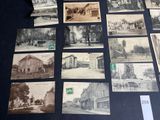 several old black and white photographs of buildings and streets on a table