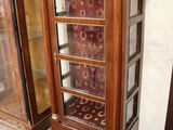 a wooden cabinet with a glass door and a clock on it