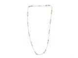 a gold necklace with a chain that has a long link and a small bead