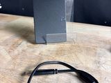 a black cable that is connected to a black device