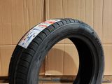 an image of a tire sitting on the floor in front of a cardboard box