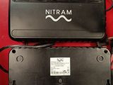 two black batteries are sitting next to each other on a red table