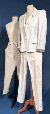 a white suit and pants on a mannequin stand