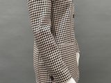 a mannequin wearing a black and white jacket and black pants