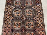 un tapis persan ancien aux motifs géométriques