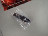 a black remote control sitting on a table next to a package