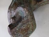a close up of a sculpture of a dog ' s head on a table