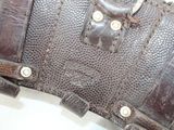 a brown leather bag with a metal buckle on it