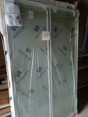 a refrigerator that is wrapped in plastic and sitting on the floor