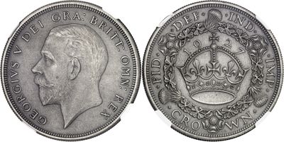 a close up of a silver coin with a crown on it