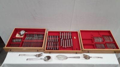 two trays with spoons and spoons in them on a table