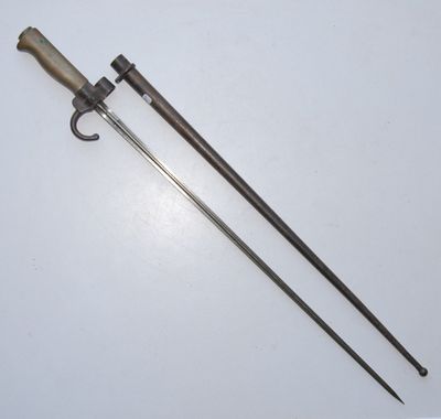 an old pair of swords with a wooden handle on a white surface
