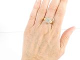 a woman ' s hand with a diamond ring on it