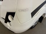a close up of a white rv parked in a garage