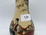 a vase that has a picture of a woman on it