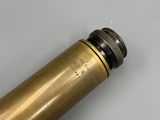 a close up of a brass cylinder with a black top