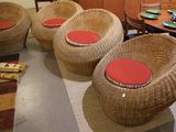 four wicker chairs and a table in a living room