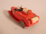 a red toy car with two people in it