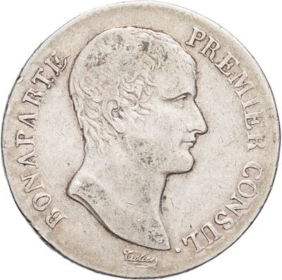 a close up of a coin with a man ' s face on it