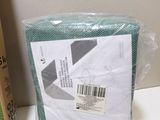 a bag of green tissue next to a pair of gloves and a pair of scissors