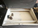 a wooden box that has a pair of shoes inside of it