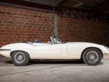 a white car parked in a garage next to a brick wall