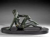 statue of a woman sitting on a black base with her legs crossed