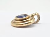 a close up of a gold ring with a blue stone on it