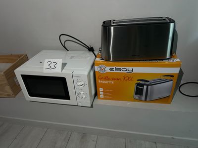 two microwaves sitting on a shelf next to each other