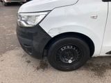 a white van with a black stripe parked in a parking lot