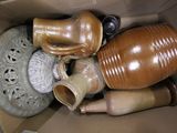 a cardboard box filled with vases and other decorative items