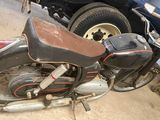 a motorcycle that is parked in a garage next to a truck