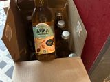 a person opening a box with a bottle of beer