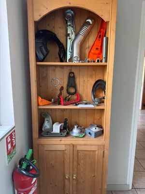 a cabinet with tools on top of it in a room