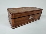 an old wooden box sitting on top of a white surface