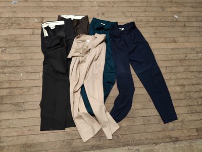 three pairs of women ' s pants laying on a wooden floor