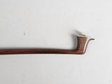 an old pipe with a wooden handle on a white surface