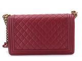 a red quilted leather shoulder bag with a chain strap